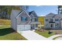 Charming two-story home with a two car garage, neutral paint and manicured landscaping at 1858 Lacebark Elm Way, Lawrenceville, GA 30045
