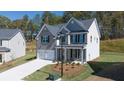 Charming two-story home with a two car garage, neutral paint and manicured landscaping at 1858 Lacebark Elm Way, Lawrenceville, GA 30045