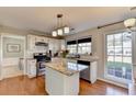 Bright kitchen featuring an island, stainless steel appliances, and hardwood floors at 2389 Lake Villas Ln, Duluth, GA 30097