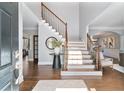 Bright foyer boasts soaring ceilings, hardwood floors, and a staircase with iron railings at 1229 Ellington Ct, Cumming, GA 30041
