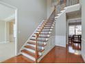 Elegant staircase features hardwood steps, wrought iron spindles, and natural light at 251 Vinings Retreat Sw Vw, Mableton, GA 30126