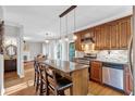A lovely kitchen with a granite island, stainless appliances, and hardwood floors, seamlessly connected to the living room at 308 Lismore Ter, Woodstock, GA 30189