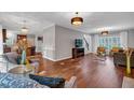 Bright and airy living room showcasing hardwood floors, recessed lighting, neutral colors, and a seamless flow to the kitchen at 308 Lismore Ter, Woodstock, GA 30189