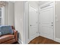 Inviting foyer with hardwood floors, a leather chair, and white doors at 2300 Peachford Rd # 4004, Atlanta, GA 30338