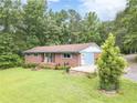 Charming one-story brick home with a well-manicured lawn and mature landscaping at 5255 Post Rd, Winston, GA 30187
