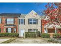 Charming townhome with a brick and beige facade, complemented by lush green bushes at 2720 Marlin Dr, Mcdonough, GA 30253