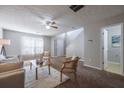 Bright living room featuring plush carpeting, neutral walls, and cozy seating at 2720 Marlin Dr, Mcdonough, GA 30253