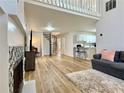 Spacious living room featuring hardwood floors, a cozy sofa, and staircase leading to upper level at 3465 Jones Ferry Ln, Alpharetta, GA 30022