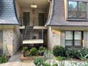 Townhome entrance featuring decorative railings, a brick courtyard, and well-maintained landscaping at 8 Cantey Nw Pl, Atlanta, GA 30327