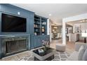 Inviting living room features custom built-ins, fireplace, and view into the dining area at 8 Cantey Nw Pl, Atlanta, GA 30327