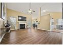 Spacious living room with a cozy fireplace, high ceilings, and an open floor plan at 129 Windy Cir, Mcdonough, GA 30253