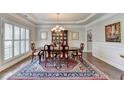 Elegant dining room with hardwood floors, chandelier, and wainscoting at 4830 Amble Trce, Cumming, GA 30040