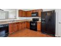 A functional kitchen with wooden cabinets and modern appliances at 622 Providence Sw Pl, Atlanta, GA 30331