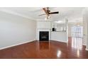 A spacious living room with a cozy fireplace and gleaming hardwood floors at 622 Providence Sw Pl, Atlanta, GA 30331