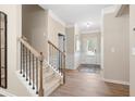 Welcoming entryway featuring wood floors, white wainscoting, a staircase with carpet, and a neutral color palette at 145 Silver Leaf Trce, Douglasville, GA 30134