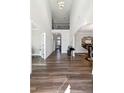 Bright foyer with high ceilings, hardwood floors, and elegant chandelier that creates a grand entrance to the home at 6375 Haystack Ct, Cumming, GA 30040