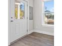 Bright entryway featuring a light-filled doorway, gray flooring, and neutral walls at 697 Fayetteville Road, Atlanta, GA 30316