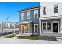 Charming two-story home featuring a welcoming porch, orange front door and modern architectural details at 697 Fayetteville Road, Atlanta, GA 30316