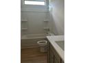 Bright bathroom with a shower-tub combo, modern vanity, and wood-look flooring at 3086 Zodiac Ct, Lawrenceville, GA 30044