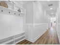 Bright hallway with custom shelving, coat racks, and wood-style flooring at 1253 Lucile Sw Ave, Atlanta, GA 30310