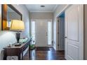 Inviting foyer featuring hardwood floors, a console table, and a front door with sidelights at 26 Crescent Ln, Dallas, GA 30157