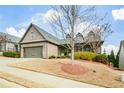 Charming brick home with a dormant lawn, attached two-car garage and covered front porch at 624 Hemlock Trl, Canton, GA 30114