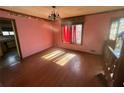 Bright dining room with hardwood floors, large window, and adjacent kitchen entrance at 708 Raven Springs Trl, Stone Mountain, GA 30087