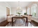 Formal dining room features an elegant chandelier and decorative windows at 120 Pine Mist Cir, Alpharetta, GA 30022