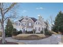 Elegant home showcasing stone accents, a manicured lawn, and classic architecture at 120 Pine Mist Cir, Alpharetta, GA 30022