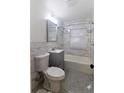 Bathroom featuring white marble tile, pedestal sink, and modern fixtures at 2791 Allegro Nw Dr, Atlanta, GA 30318