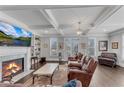 Cozy living room featuring fireplace, coffered ceilings, and plantation shutters at 2880 Stonehall Ct # 2, Atlanta, GA 30339