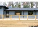 Modern home with a new deck that offers stylish outdoor living space, new door, and gray brick at 1120 Taliwa Ne Trl, Marietta, GA 30068