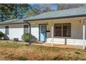 Welcoming single-story home featuring a covered front porch, neat landscaping, and a blue front door at 170 Roberts Rd, Covington, GA 30016