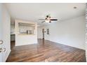 Open living room showcasing hardwood floors, a ceiling fan, and seamless flow into the kitchen area at 170 Roberts Rd, Covington, GA 30016