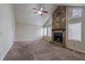 Spacious living room with a stone fireplace, vaulted ceilings, and lots of natural light at 123 Williamsburg Ln, Woodstock, GA 30189