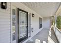 Inviting front porch featuring a decorative glass front door and white railings at 211 Garden W Walk, Hampton, GA 30228