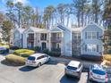 Beautiful condo community with blue siding, stone accents, balconies, and ample parking at 301 Madison Se Ct # 301, Smyrna, GA 30080