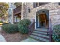 View of an entrance to the building with stone accents and wood steps leading up to the door at 301 Madison Se Ct # 301, Smyrna, GA 30080