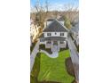 Aerial view of a meticulously landscaped property featuring a traditional home with a stone porch and expansive lawn at 1330 Lanier Ne Blvd, Atlanta, GA 30306