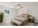 Cozy bedroom with a ceiling fan, a window overlooking the outdoors, and neutral décor at 237 Kindness Cir, Mcdonough, GA 30252