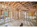 Interior framing of a room showing exposed studs, new window framing and unfinished floor at 1038 Orlando Sw Pl, Atlanta, GA 30311