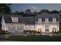 Elegant two-story home at dusk, showcasing a two-car garage and a welcoming covered front porch, exuding warmth and sophistication at 221 Valley Ridge Dr, Carrollton, GA 30116