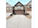 Exterior view of townhomes with two car garages and concrete driveway at 6642 Story Circle Cir, Norcross, GA 30093