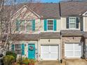 Inviting townhome featuring a blue front door and attached one-car garage at 820 Ash St, Canton, GA 30114