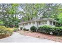 Side view of well-maintained home with a driveway and landscaped yard offering curb appeal at 850 Moores Mill Nw Rd, Atlanta, GA 30327