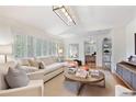 Cozy living room with a fireplace, plantation shutters and an open doorway to the dining room at 850 Moores Mill Nw Rd, Atlanta, GA 30327