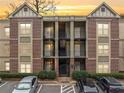 Charming brick condo building with courtyard access and well-maintained landscaping at sunset at 1903 Anjaco Nw Rd # 3, Atlanta, GA 30309