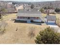 Sprawling property featuring a brick home, detached garage, and large yard in a suburban neighborhood at 3200 Fence Rd, Dacula, GA 30019