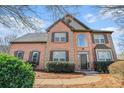 Attractive two-story brick home boasts manicured shrubs and a symmetrical facade at 3215 Belford Dr, Marietta, GA 30066