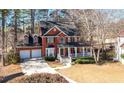 Beautiful brick home with a two-car garage, front porch, and lush green lawn at 9937 Between The Grns, Villa Rica, GA 30180